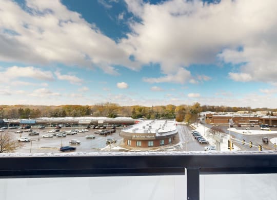 a view of a parking lot from a balcony of a building