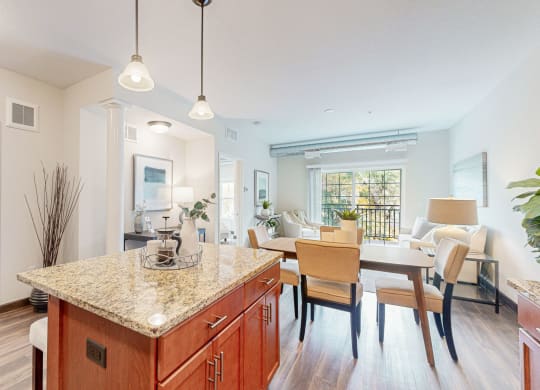 a kitchen with a granite counter top and a dining room table