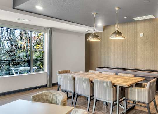 A conference room with a long table and chairs.