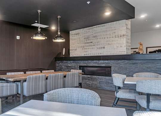 A modern dining area with a long table and chairs.