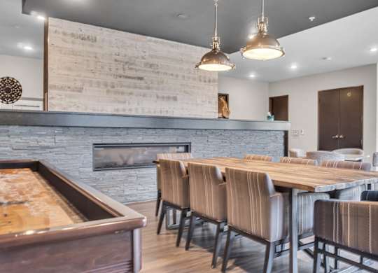 A modern dining room with a fireplace and wooden furniture.