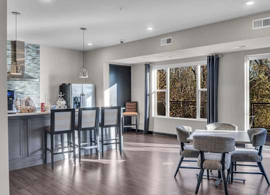 A modern kitchen with a dining table and chairs.