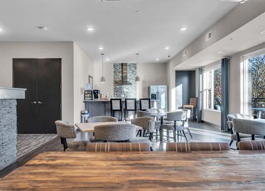 A modern living room with a stone fireplace and a large window.