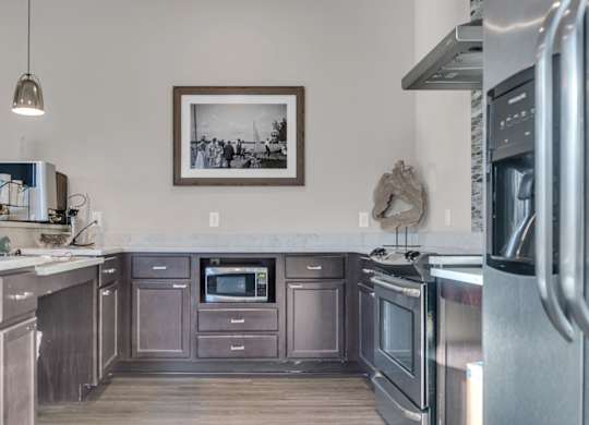 A kitchen with stainless steel appliances and wooden cabinets.
