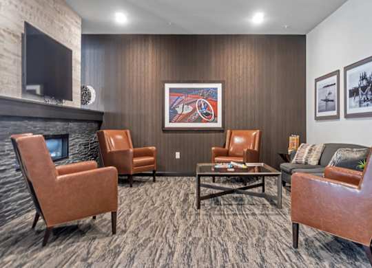 A living room with a fireplace and a painting on the wall.