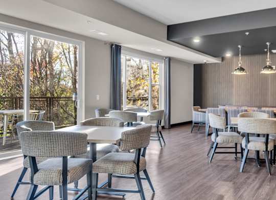 A dining room with a long table and chairs.