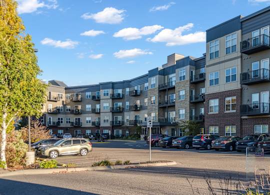 A parking lot in front of apartment buildings.