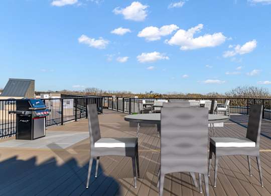 A deck with chairs and a table is set up on a sunny day.