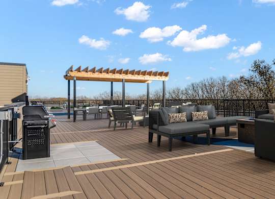 A wooden deck with a table and chairs and a canopy.
