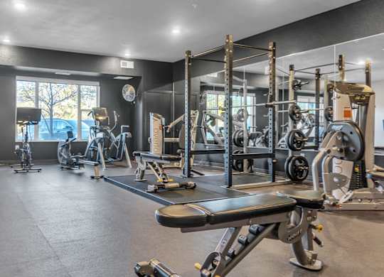 A spacious gym with a variety of equipment including treadmills, weights, and exercise machines.