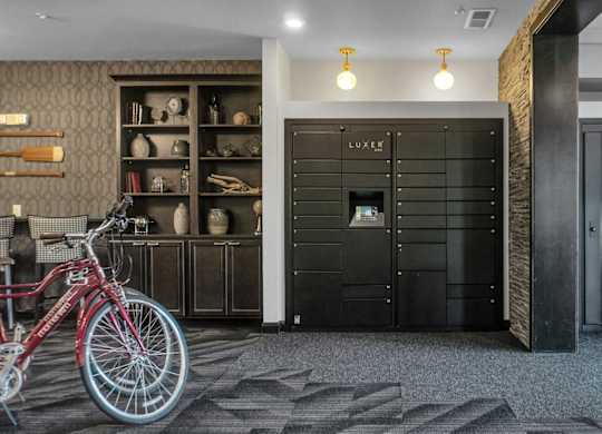 A red bicycle is parked in front of a black door with a sign that says