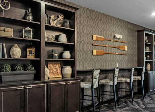 A room with a brown cabinet and a grey wall.