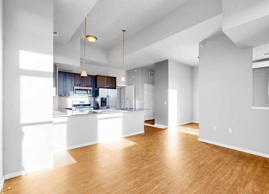 A large open room with wooden floors and white walls.