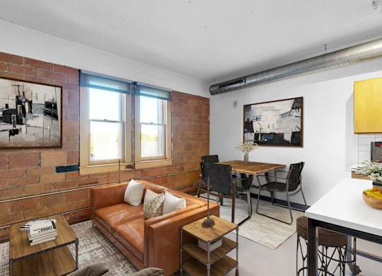 A living room with a brown couch and a coffee table.