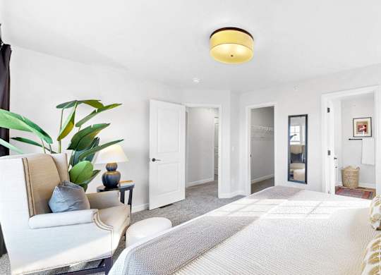 A well-lit bedroom at Field and Grove Townhomes of Champlin, Minnesota