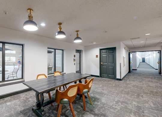 A conference room with a long table and chairs.