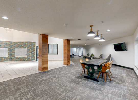 A conference room with a long table and chairs.
