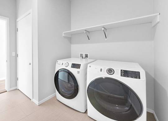 Two front load washing machines in a laundry room.