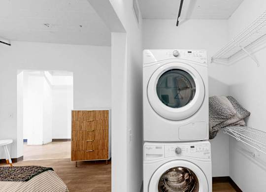 A white washing machine is in a laundry room.
