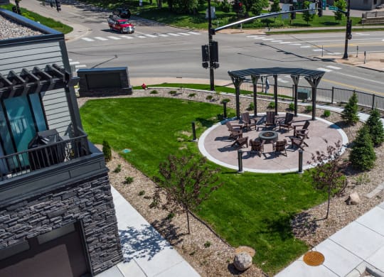 an aerial view of a park with a seating area on a city street