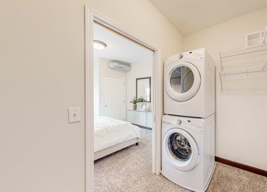 a washer and dryer in a bathroom next to a closet