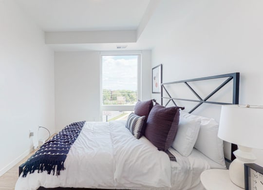 Bedroom with cozy bed at CityLine Apartments, Minneapolis