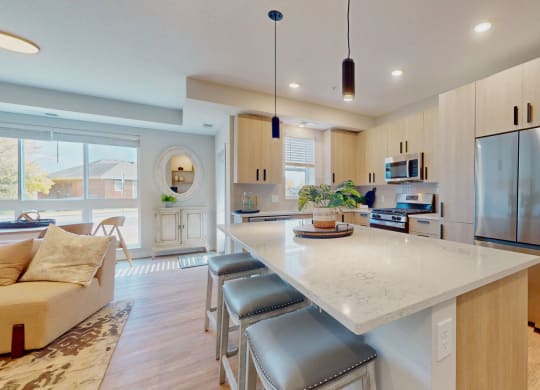 a kitchen with a large island with stools