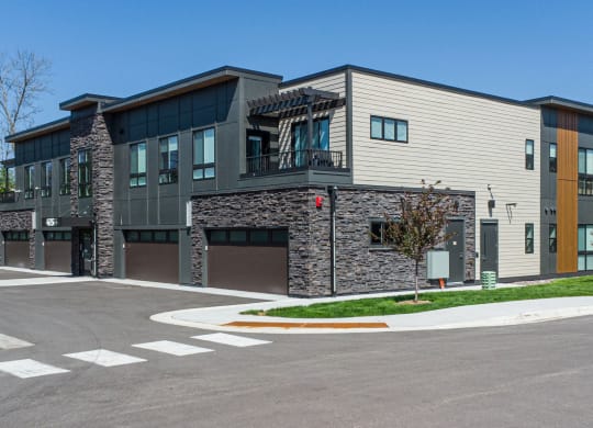 a modern apartment building with a parking lot