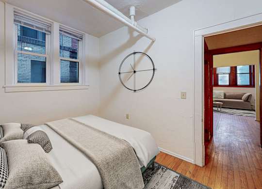 A bedroom with a bed and a couch.
