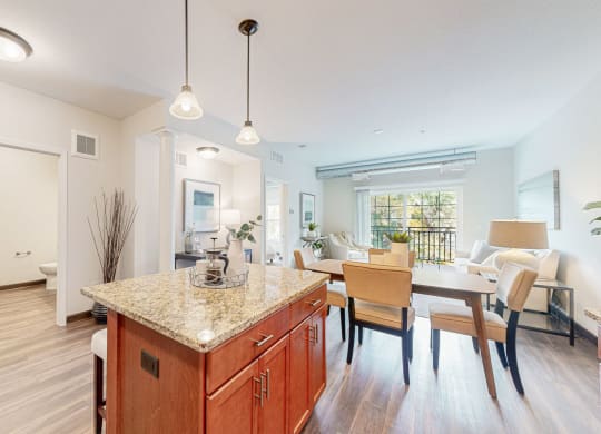 a kitchen with a marble counter top and a dining room table
