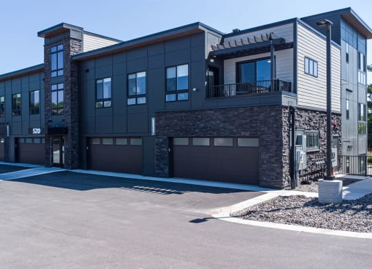 a large building with a driveway and garage doors