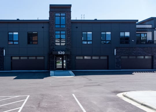 an empty parking lot in front of a building