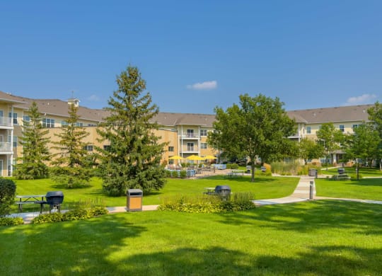 a large open space with green grass and beautiful landscaping