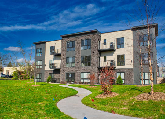 exterior image of an apartment building with landscaping
