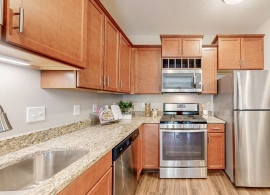 a kitchen with stainless steel appliances and wooden cabinets