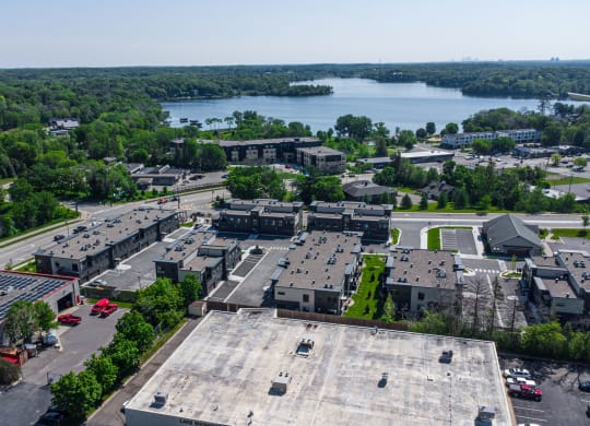 an aerial view of a city with a lake in the background
