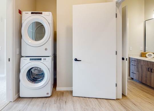a front load washer and dryer are stacked on top of each other in a laundry