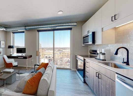 a kitchen and living room in a 555 waverly unit