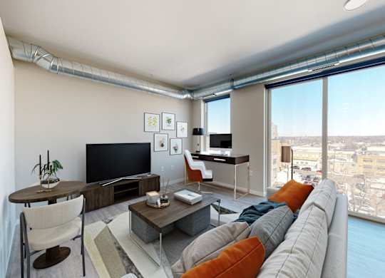 a living room with a large window and a view of a city
