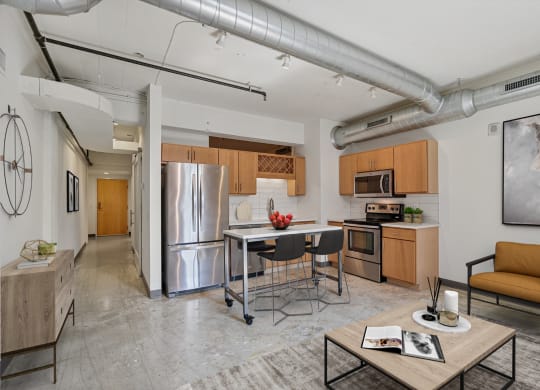 a living room with a kitchen and a table with chairs