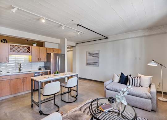 A modern kitchen with a dining table and a couch.