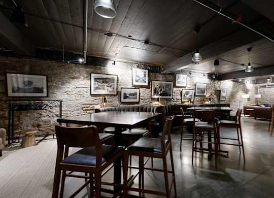 A restaurant with a long table and chairs in the center of the room.