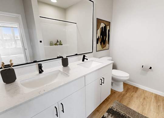 A bathroom with a white sink and toilet.