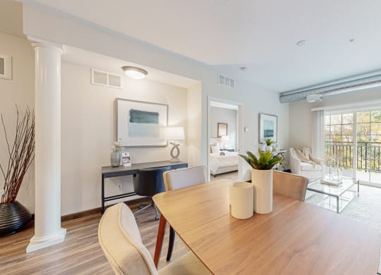 a living room and dining room with a table and chairs