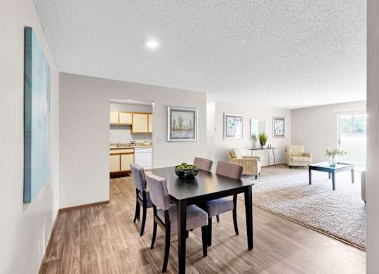 A dining room with a table and chairs is shown.