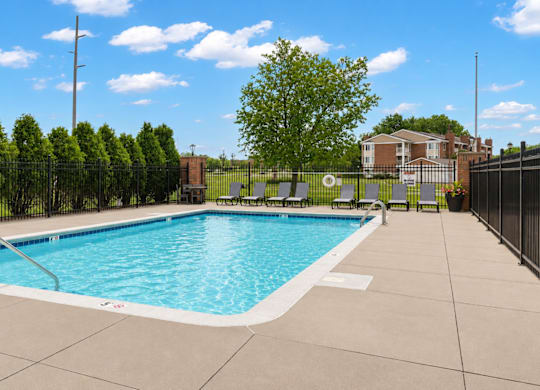 A small pool surrounded by a black fence.