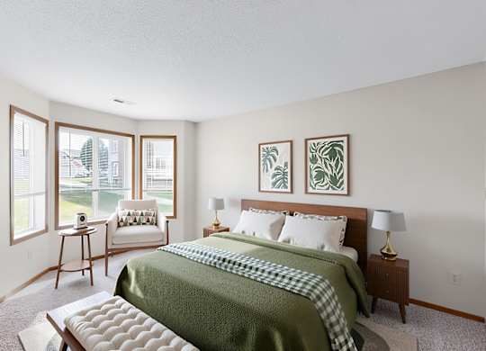 A bedroom with a bed, nightstand, and window.
