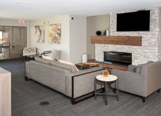 community room with seating, tv and fireplace