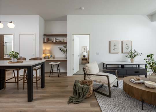 A modern living room with a dining table and chairs.