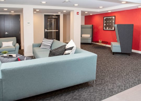 Community room  With couch and chairs at Eagan Place Apartments in Eagan, MN